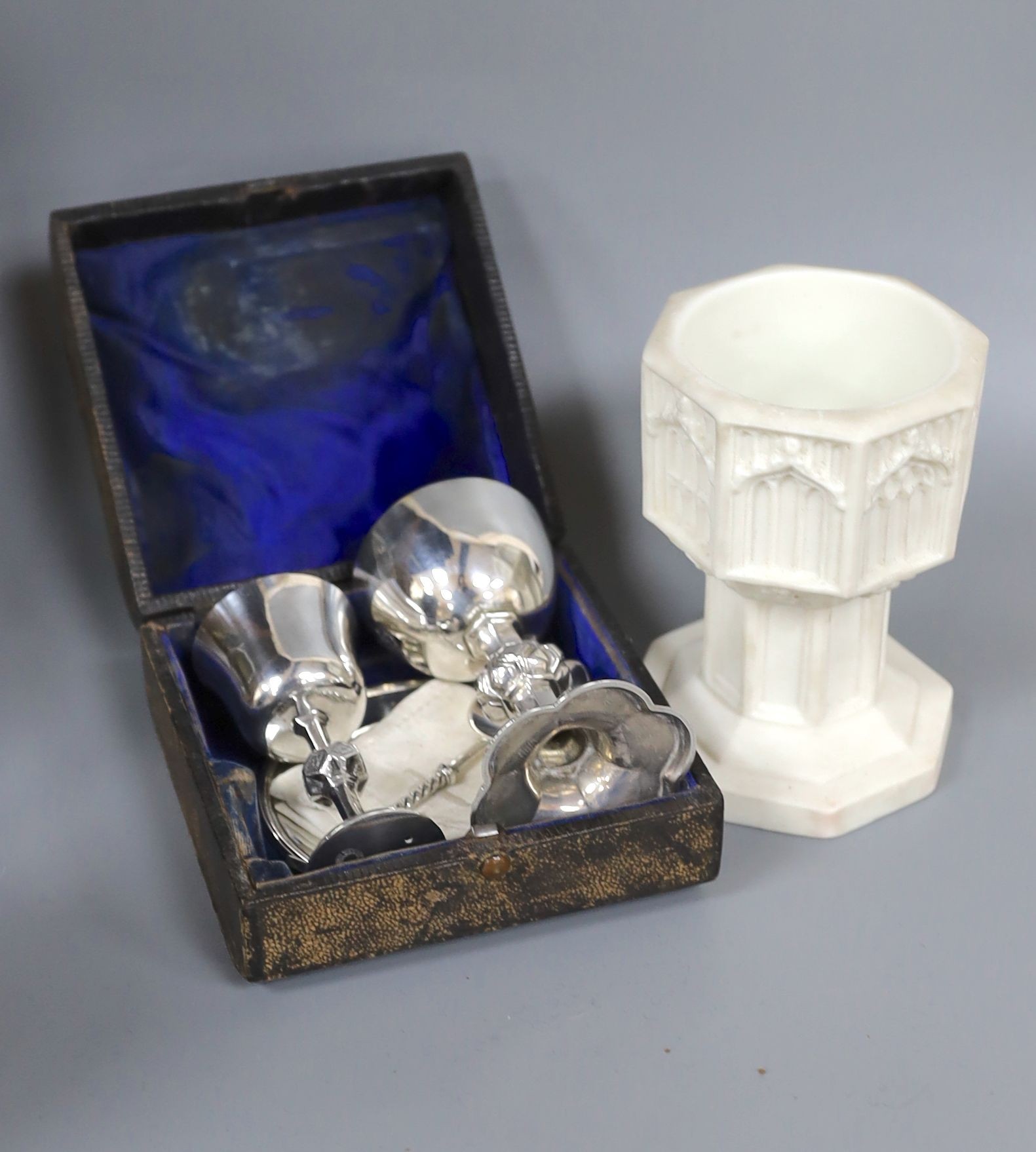 A Victorian Parian baptismal font, 11cm, and a Victorian silver travelling communion set, both cased